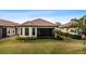 Single-story home with a screened-in patio and lush lawn at 8424 Alberata Vista Dr, Tampa, FL 33647