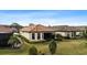 Single-story home with a screened-in patio and landscaped yard at 8424 Alberata Vista Dr, Tampa, FL 33647