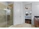 Modern bathroom with a glass shower enclosure and view of bedroom at 8424 Alberata Vista Dr, Tampa, FL 33647