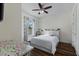 Bright bedroom with wood floors and ceiling fan at 8424 Alberata Vista Dr, Tampa, FL 33647