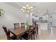 Elegant dining room with a wood table and chairs, kitchen view at 8424 Alberata Vista Dr, Tampa, FL 33647
