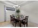 Bright dining room with a dark wood table and chandelier at 8424 Alberata Vista Dr, Tampa, FL 33647