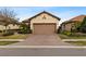 House exterior featuring a two-car garage and well-manicured landscaping at 8424 Alberata Vista Dr, Tampa, FL 33647