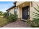 Inviting exterior entrance with a dark door and landscaped walkway at 8424 Alberata Vista Dr, Tampa, FL 33647