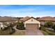 Single-story home with two-car garage and landscaping at 8424 Alberata Vista Dr, Tampa, FL 33647