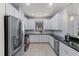 Well-equipped kitchen with white cabinets and stainless steel appliances at 8424 Alberata Vista Dr, Tampa, FL 33647