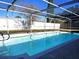 Inviting swimming pool with screened enclosure at 8523 Viva Via Dr, Hudson, FL 34667