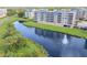 Aerial view displaying the scenic lake behind the multi-story condominiums at 960 Starkey Rd # 7103, Largo, FL 33771