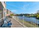 Balcony view of a serene pond with a fountain and neighboring building at 960 Starkey Rd # 7103, Largo, FL 33771