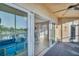 View from the balcony through sliding glass doors into the home, with golf course in the distance at 960 Starkey Rd # 7103, Largo, FL 33771