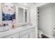 Bright bathroom featuring a sleek white vanity with storage and a separate toilet area at 960 Starkey Rd # 7103, Largo, FL 33771
