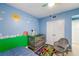 Cute bedroom with blue walls, a grey chair and decor at 960 Starkey Rd # 7103, Largo, FL 33771