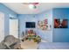 Cute bedroom with blue walls, a grey chair and decor at 960 Starkey Rd # 7103, Largo, FL 33771