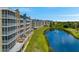 Beautiful condominiums overlooking a serene lake with a fountain and lush green surroundings at 960 Starkey Rd # 7103, Largo, FL 33771
