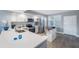 Bright kitchen with stainless steel appliances, white cabinets, and island prep space at 960 Starkey Rd # 7103, Largo, FL 33771