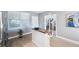 Kitchen island featuring white cabinets and a wood cutting board, close to doorway at 960 Starkey Rd # 7103, Largo, FL 33771