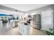 Open kitchen featuring stainless appliances, white cabinets, and an adjacent living area at 960 Starkey Rd # 7103, Largo, FL 33771