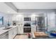 Bright kitchen with stainless steel appliances, white cabinets, and food prep island at 960 Starkey Rd # 7103, Largo, FL 33771