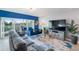 A modern living room with stylish furnishings and a view of a balcony and golf course at 960 Starkey Rd # 7103, Largo, FL 33771