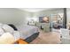 Main bedroom with TV, dresser, and access to patio at 9940 47Th N Ave # 120, St Petersburg, FL 33708