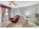 Cozy bedroom with a recliner, end table, and ceiling fan at 9940 47Th N Ave # 120, St Petersburg, FL 33708
