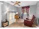 Bright bedroom with a TV, dresser, and comfy recliner at 9940 47Th N Ave # 120, St Petersburg, FL 33708