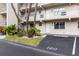Condo building exterior with parking and landscaping at 9940 47Th N Ave # 120, St Petersburg, FL 33708