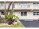 Condo building exterior with palm trees and a walkway at 9940 47Th N Ave # 120, St Petersburg, FL 33708