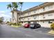 Two-story condo building with parking and tropical landscaping at 9940 47Th N Ave # 120, St Petersburg, FL 33708