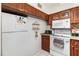 Kitchen with wood cabinets, granite counters and appliances at 9940 47Th N Ave # 120, St Petersburg, FL 33708