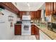 Galley kitchen with wood cabinets and granite countertops at 9940 47Th N Ave # 120, St Petersburg, FL 33708