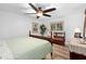 Serene bedroom with wooden bed frame, light green bedding and ceiling fan at 1001 Crocker Ln, Plant City, FL 33565