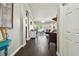 View down long entry hall showcasing dark hardwood floors at 10734 Moss Island Dr, Riverview, FL 33569