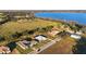 Stunning aerial view of the property showcasing the home's location near a lake and farmland at 10920 Flint Estates Dr, Thonotosassa, FL 33592