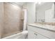 Well-lit bathroom featuring a walk-in shower with neutral tiling and a vanity with granite countertop at 10920 Flint Estates Dr, Thonotosassa, FL 33592