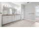 Elegant bathroom featuring a double sink vanity with granite countertops and tiled flooring at 10920 Flint Estates Dr, Thonotosassa, FL 33592