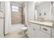 Well-lit bathroom featuring a shower-tub combo with neutral tiling and a vanity with granite countertop at 10920 Flint Estates Dr, Thonotosassa, FL 33592