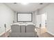 Media room with a large screen and white leather electric reclining sofa at 10920 Flint Estates Dr, Thonotosassa, FL 33592
