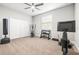 Carpeted exercise room with exercise equipment, weights, and ceiling fan at 10920 Flint Estates Dr, Thonotosassa, FL 33592