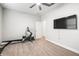 Spacious exercise room featuring a ceiling fan, a tv, and an exercise machine at 10920 Flint Estates Dr, Thonotosassa, FL 33592