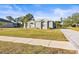 Charming single-story home with a well-manicured lawn and a brick-paved driveway at 10920 Flint Estates Dr, Thonotosassa, FL 33592