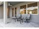 Outdoor seating area featuring two chairs and a small table with views to the home's interior at 10920 Flint Estates Dr, Thonotosassa, FL 33592