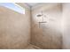 Shower with beige tiling, a rainfall shower head, and built-in niche at 10920 Flint Estates Dr, Thonotosassa, FL 33592