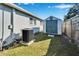 Well-maintained backyard with a storage shed and AC unit at 11225 Scotchwood Dr, Riverview, FL 33579