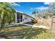 Landscaped backyard with a spacious patio and wooden fence at 11225 Scotchwood Dr, Riverview, FL 33579
