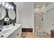 Spa-like bathroom with double vanity, bathtub, and glass shower at 11225 Scotchwood Dr, Riverview, FL 33579