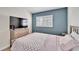 Bedroom with double bed, dresser, and a large TV at 11225 Scotchwood Dr, Riverview, FL 33579