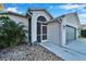 House front entrance with a screened-in porch and green door at 11225 Scotchwood Dr, Riverview, FL 33579