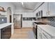 Modern kitchen with stainless steel appliances and white shaker cabinets at 11225 Scotchwood Dr, Riverview, FL 33579