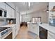 Modern kitchen with white cabinets, stainless steel appliances, and a large island at 11225 Scotchwood Dr, Riverview, FL 33579